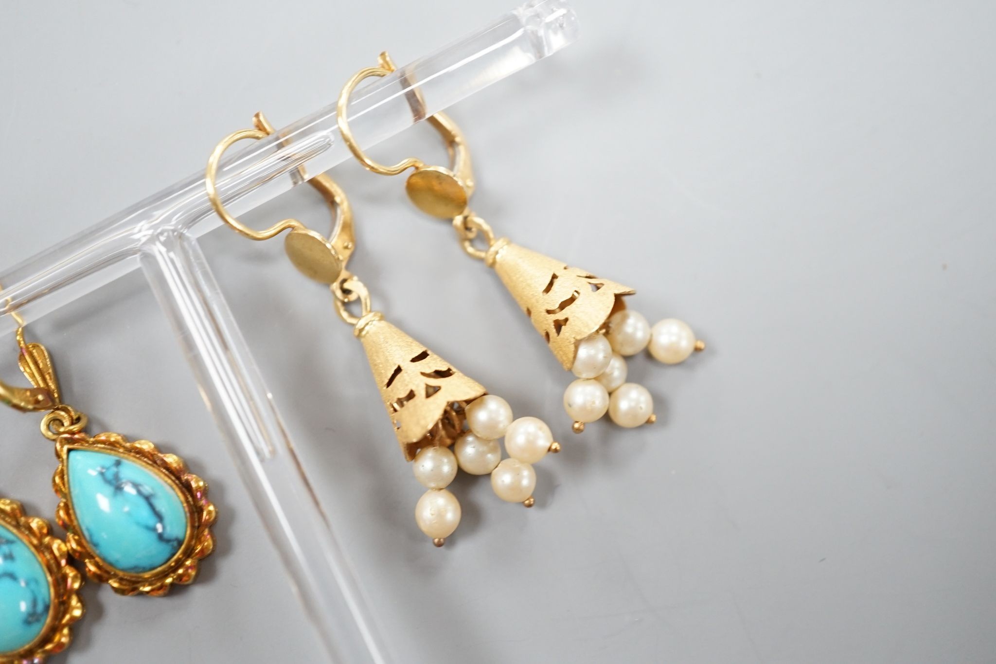 Two modern pairs of 18ct and gem set drop earrings, one with cultured pearl, 42mm and one with turquoise, gross weight 11.7 grams.